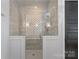 Walk-in shower with neutral tiling and glass enclosure at 4109 Arbor Spring Ct, Belmont, NC 28012