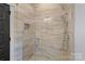 Modern walk-in shower with light colored ceramic tiling and a rainfall shower head at 4109 Arbor Spring Ct, Belmont, NC 28012