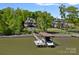 Lakefront home boasts a private dock with a boat lift, providing easy access to water activities at 4109 Arbor Spring Ct, Belmont, NC 28012