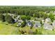 Stunning aerial view of a home with a private pool nestled in a lush, wooded neighborhood at 4705 Granite Ct, Indian Trail, NC 28079