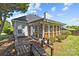 Back exterior showcasing a screened porch with deck access, and stairs leading down to the yard at 4705 Granite Ct, Indian Trail, NC 28079