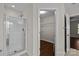 Bathroom featuring glass-enclosed shower and walk-in closet with wire shelving at 4705 Granite Ct, Indian Trail, NC 28079