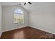 Well-lit bedroom with vaulted ceilings, arched window, and hardwood floors at 4705 Granite Ct, Indian Trail, NC 28079