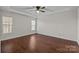 Comfortable bedroom features a ceiling fan, hardwood floors, and natural light at 4705 Granite Ct, Indian Trail, NC 28079