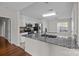 Bright kitchen with white cabinets, granite countertops, and stainless steel appliances at 4705 Granite Ct, Indian Trail, NC 28079