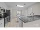 Modern kitchen features granite counters, stainless steel appliances, and an open layout at 4705 Granite Ct, Indian Trail, NC 28079