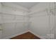 Spacious walk-in closet featuring custom wire shelving and hardwood floors at 4705 Granite Ct, Indian Trail, NC 28079