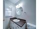 Well-lit bathroom features a single sink vanity and mirror with an additional window for natural light at 4903 Walt Gay Rd, Monroe, NC 28112