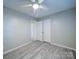 This bedroom features wood-look flooring, a ceiling fan, closet, and neutral wall color at 4903 Walt Gay Rd, Monroe, NC 28112
