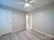 This bedroom features wood-look flooring, a ceiling fan, closet, and neutral wall color at 4903 Walt Gay Rd, Monroe, NC 28112