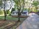 Well-maintained home with a brick foundation, black shutters, and a long driveway at 4903 Walt Gay Rd, Monroe, NC 28112