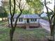 Lovely one-story home featuring a brick foundation, covered porch, and lush green surroundings at 4903 Walt Gay Rd, Monroe, NC 28112