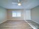 Bright living room featuring neutral walls, a ceiling fan, and modern wood-look flooring at 4903 Walt Gay Rd, Monroe, NC 28112