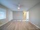 Spacious living room with a ceiling fan, natural light, and beautiful wood-look flooring throughout at 4903 Walt Gay Rd, Monroe, NC 28112