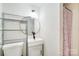 Small bathroom with black fixtures, white vanity and toilet, and a shower with a pink curtain at 4915 Huntington Farm Rd, Catawba, SC 29704