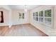 Bright dining room featuring wood floors, contemporary lighting, and shuttered windows at 4915 Huntington Farm Rd, Catawba, SC 29704