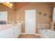 This bathroom offers a soaking tub, vanity with sink, and a neutral color palette at 503 Kinsey Creek Ct, Rock Hill, SC 29730