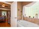 This bathroom features a soaking tub with tile surround and a decorative glass block window at 503 Kinsey Creek Ct, Rock Hill, SC 29730