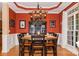 Formal dining room boasts an unique chandelier, wainscoting, and black wood furniture at 503 Kinsey Creek Ct, Rock Hill, SC 29730