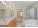 Bright bathroom with a double vanity and bathtub/shower combo at 5311 Courtfield Dr, Indian Trail, NC 28079