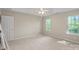 Bedroom featuring neutral walls, carpet, a ceiling fan, and natural light from the windows at 5311 Courtfield Dr, Indian Trail, NC 28079