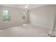 Bright bedroom with natural light featuring neutral walls, carpet, and a ceiling fan at 5311 Courtfield Dr, Indian Trail, NC 28079