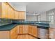 Well-appointed kitchen with wood cabinets, modern backsplash, and stainless steel dishwasher at 5311 Courtfield Dr, Indian Trail, NC 28079