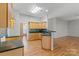 Kitchen with hardwood floors, light wood cabinets, dark countertops, and stone backsplash at 5311 Courtfield Dr, Indian Trail, NC 28079