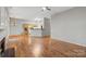 Spacious open living room with hardwood floors, fireplace, and connected kitchen at 5311 Courtfield Dr, Indian Trail, NC 28079