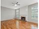 Cozy living room featuring hardwood floors, fireplace, and bright windows with blinds at 5311 Courtfield Dr, Indian Trail, NC 28079