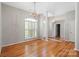 Living room featuring hardwood floors, natural light, white columns, and chandelier at 5311 Courtfield Dr, Indian Trail, NC 28079