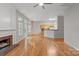 Bright living room featuring a fireplace, hardwood floors, and a view into the kitchen at 5311 Courtfield Dr, Indian Trail, NC 28079
