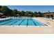 Large swimming pool with multiple lanes, perfect for exercise or relaxation, surrounded by shaded cabanas at 5311 Courtfield Dr, Indian Trail, NC 28079