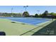 Well-maintained tennis courts with new nets, surrounded by trees and fencing for privacy at 5311 Courtfield Dr, Indian Trail, NC 28079