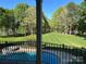 Scenic view of the backyard with pool and lake, as seen from the home's balcony at 5517 Mountain Point Ln, Charlotte, NC 28216
