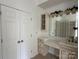 Bathroom with storage cabinets, vanity, and view of glass block shower at 5517 Mountain Point Ln, Charlotte, NC 28216