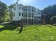 Multi-story home with balconies, a fenced yard, and beautiful landscaping for outdoor enjoyment at 5517 Mountain Point Ln, Charlotte, NC 28216