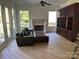 Spacious living room featuring a fireplace, hardwood floors, and leather sofa at 5517 Mountain Point Ln, Charlotte, NC 28216