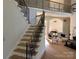 Staircase view of bright living room with wood floors, high ceilings, decorative chandelier and ornate iron railing at 5517 Mountain Point Ln, Charlotte, NC 28216