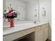 Bright bathroom vanity with large mirror and stylish floral arrangement at 6009 Glen Manor Dr, Charlotte, NC 28269