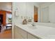 Well-lit bathroom vanity with white cabinets, mirror, and decorative accents at 6009 Glen Manor Dr, Charlotte, NC 28269