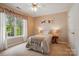 Charming bedroom with natural light, cozy bed, and views of the lush outdoors at 6009 Glen Manor Dr, Charlotte, NC 28269