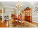 Formal dining room with a chandelier, china cabinet, and views into the living room through an archway at 6009 Glen Manor Dr, Charlotte, NC 28269