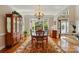Bright dining room with large windows, chandelier, classic wood furniture, and an inviting atmosphere at 6009 Glen Manor Dr, Charlotte, NC 28269