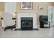 This home features an elegant fireplace with white mantle and tile flooring throughout at 6009 Glen Manor Dr, Charlotte, NC 28269