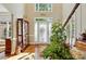 Bright foyer features hardwood floors, soaring ceilings, and decorative glass cabinet at 6009 Glen Manor Dr, Charlotte, NC 28269