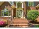 Inviting front entrance with brick steps, black railings, and decorative floral wreath at 6009 Glen Manor Dr, Charlotte, NC 28269