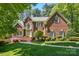 Charming two-story brick home with manicured lawn, walkway, and inviting entrance at 6009 Glen Manor Dr, Charlotte, NC 28269