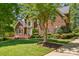 Beautiful brick home featuring a well-kept lawn and mature landscaping, enhancing curb appeal at 6009 Glen Manor Dr, Charlotte, NC 28269
