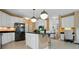 Modern kitchen with a center island, stainless steel appliances, and lots of cabinet space at 6009 Glen Manor Dr, Charlotte, NC 28269